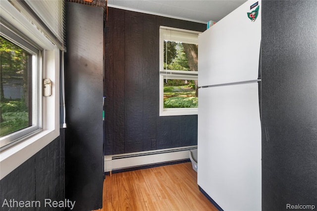 6600 W Shore Dr, Weidman, MI 48893 - spare room with wood finished floors and a baseboard radiator