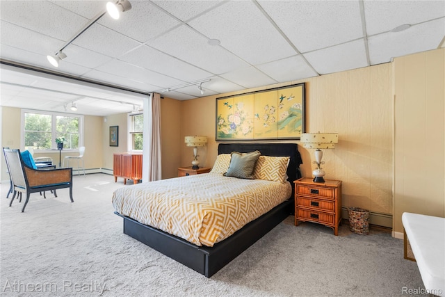 6600 W Shore Dr, Weidman, MI 48893 - carpeted bedroom with track lighting, a baseboard heating unit, and a drop ceiling