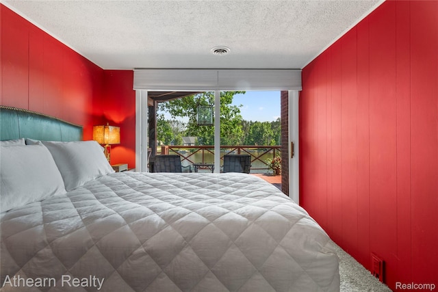 6600 W Shore Dr, Weidman, MI 48893 - bedroom featuring access to outside and a textured ceiling