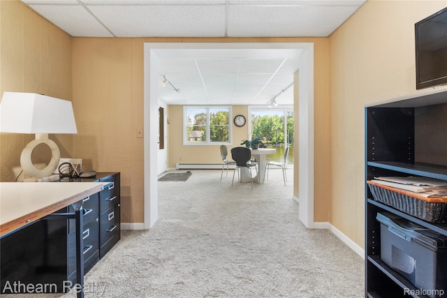 6600 W Shore Dr, Weidman, MI 48893 - interior space featuring light carpet, a baseboard radiator, dark cabinets, and a drop ceiling