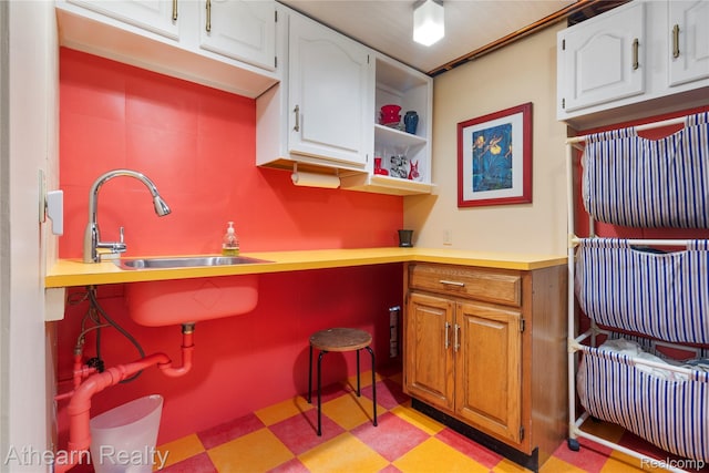 6600 W Shore Dr, Weidman, MI 48893 - kitchen featuring light floors, white cabinetry, light countertops, and built in study area