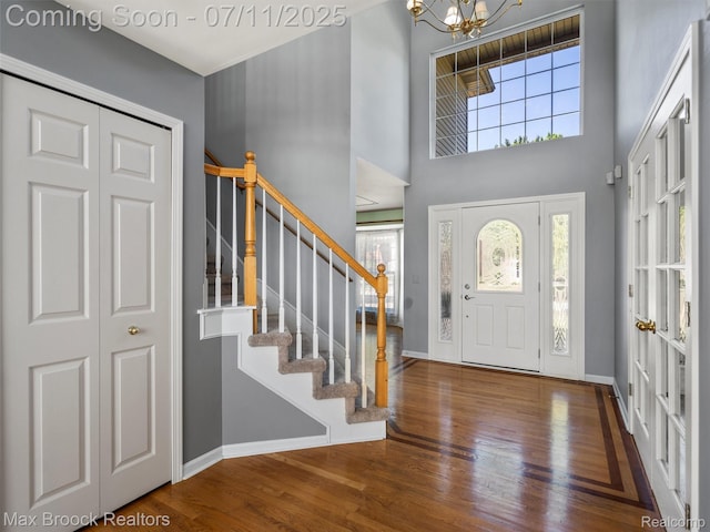 39104 Devonshire Ct, Harrison Township, MI 48045 - foyer with wood finished floors, stairs, a chandelier, and a high ceiling
