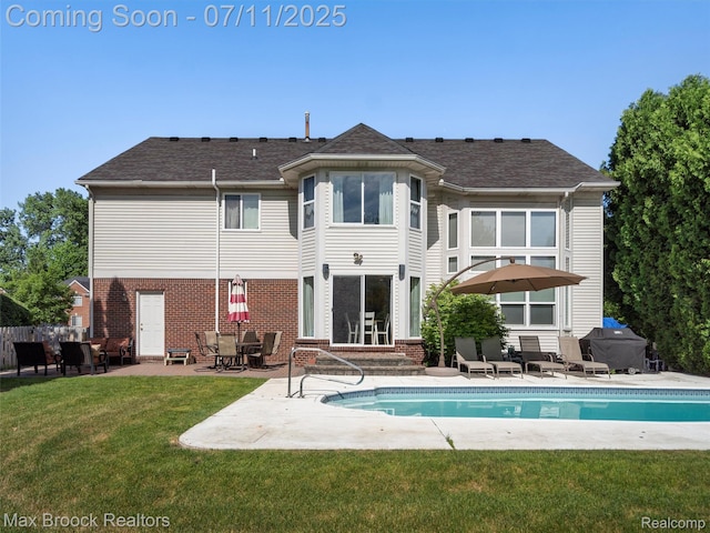 39104 Devonshire Ct, Harrison Township, MI 48045 - rear view of property with entry steps, a patio area, a yard, brick siding, and an outdoor pool