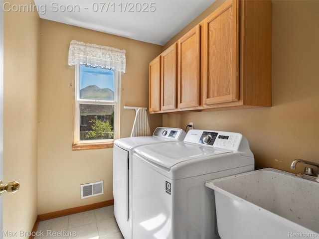 39104 Devonshire Ct, Harrison Township, MI 48045 - washroom featuring cabinet space, washing machine and clothes dryer, and light tile patterned floors