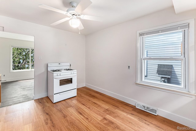 21048 Audrey Ave, Warren, MI 48091 - kitchen featuring white gas stove, light wood finished floors, and a ceiling fan