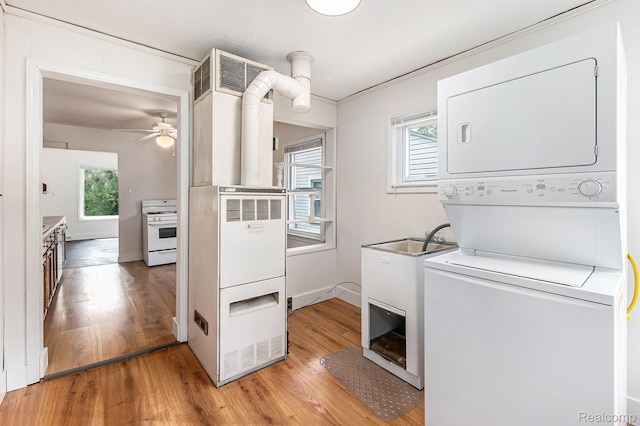 21048 Audrey Ave, Warren, MI 48091 - washroom with stacked washer / drying machine, light wood-type flooring, plenty of natural light, and ceiling fan