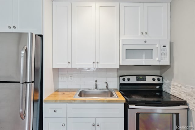 637 Lexington Ave, East Lansing, MI 48823 - kitchen featuring stainless steel appliances, backsplash, white cabinets, and butcher block counters
