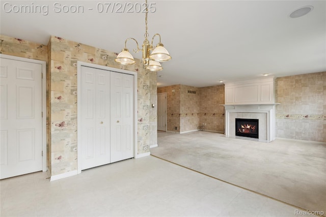 10074 Pond View Trl, Holly, MI 48442 - unfurnished living room featuring a chandelier and a warm lit fireplace