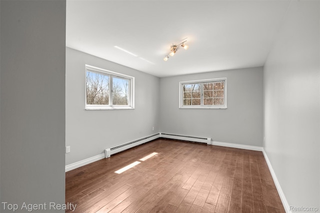 1593 Parke St, Rochester Hills, MI 48307 - spare room with plenty of natural light, a baseboard radiator, a baseboard heating unit, and wood finished floors