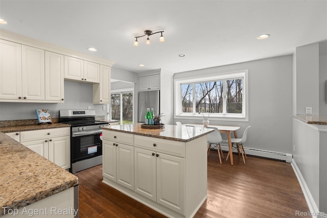 1593 Parke St, Rochester Hills, MI 48307 - kitchen featuring appliances with stainless steel finishes, a baseboard heating unit, dark wood-style flooring, recessed lighting, and light stone counters