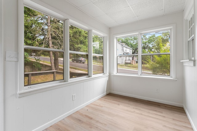 1680 Kalamazoo Ave SE, Grand Rapids, MI 49507 - unfurnished sunroom with healthy amount of natural light, wood finished floors, and a paneled ceiling