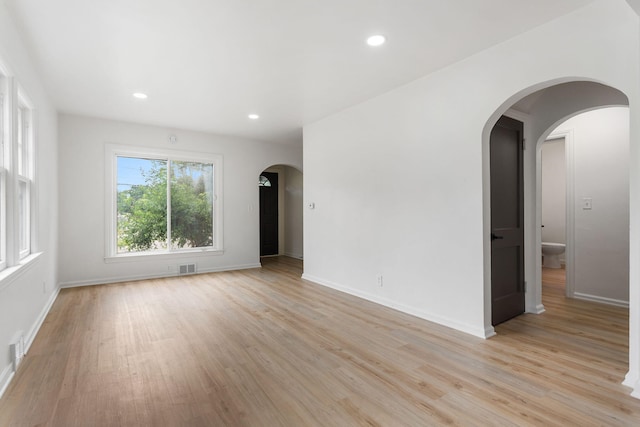 1680 Kalamazoo Ave SE, Grand Rapids, MI 49507 - spare room with light wood finished floors, recessed lighting, and arched walkways