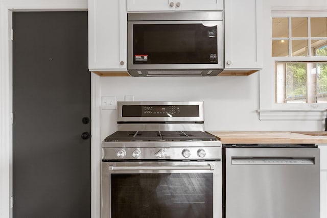 1680 Kalamazoo Ave SE, Grand Rapids, MI 49507 - kitchen featuring appliances with stainless steel finishes, white cabinets, and butcher block countertops