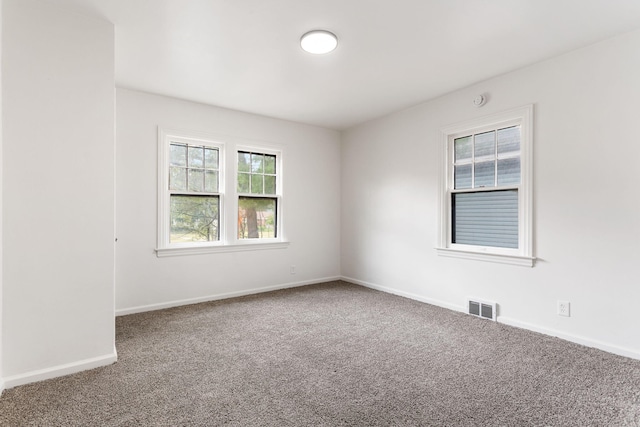 1680 Kalamazoo Ave SE, Grand Rapids, MI 49507 - carpeted empty room with baseboards and a smoke detector