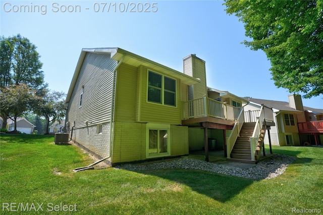 1211 Creek View Ct, Burton, MI 48509 - back of property with a chimney, stairway, a deck, and a lawn
