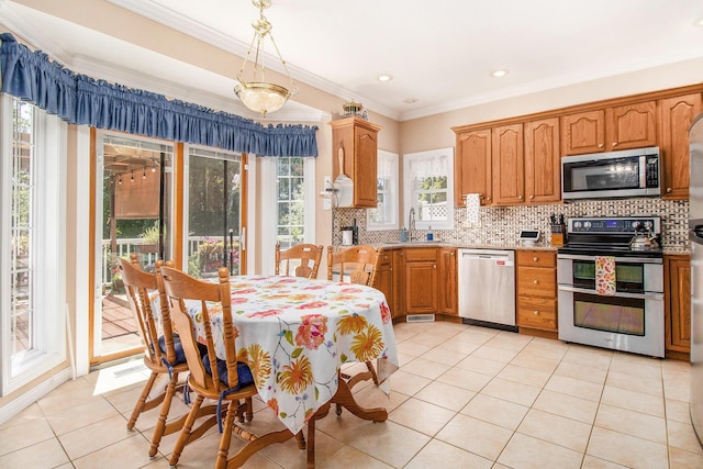 4673 Chasemoor Dr, Portage, MI 49024 - kitchen with stainless steel appliances, light tile patterned flooring, ornamental molding, light countertops, and backsplash