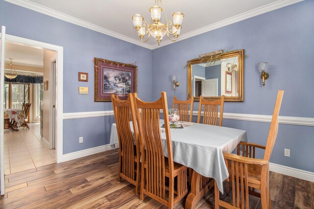 4673 Chasemoor Dr, Portage, MI 49024 - dining room with a chandelier, wood finished floors, and crown molding