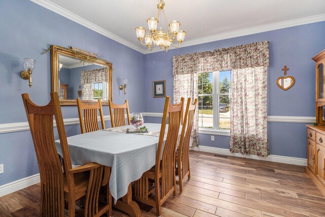 4673 Chasemoor Dr, Portage, MI 49024 - dining area featuring a chandelier, light wood-type flooring, and ornamental molding