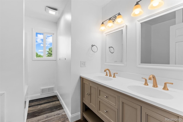 7900 Wiggins Rd, Howell, MI 48855 - bathroom with double vanity, wood finished floors, and a bathtub