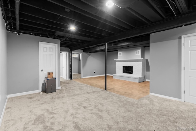 7900 Wiggins Rd, Howell, MI 48855 - finished basement with carpet floors and a brick fireplace