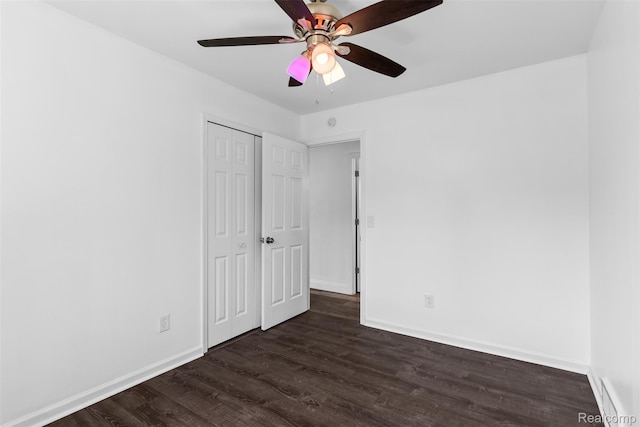 7900 Wiggins Rd, Howell, MI 48855 - unfurnished bedroom featuring dark wood finished floors, a closet, and a ceiling fan