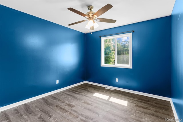7900 Wiggins Rd, Howell, MI 48855 - spare room featuring wood finished floors and ceiling fan