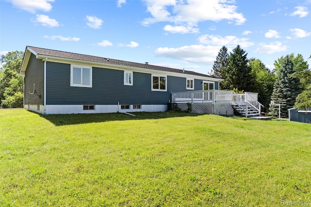 7900 Wiggins Rd, Howell, MI 48855 - rear view of house featuring a deck and a lawn