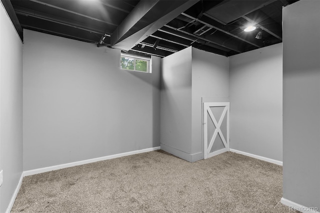 7900 Wiggins Rd, Howell, MI 48855 - below grade area featuring carpet and baseboards