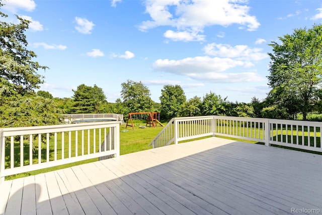 7900 Wiggins Rd, Howell, MI 48855 - wooden terrace with a playground, a lawn, and view of scattered trees
