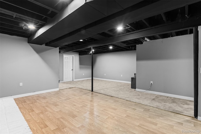 7900 Wiggins Rd, Howell, MI 48855 - finished below grade area with wood finished floors and baseboards