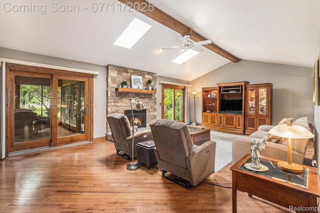 5131 Standish Dr, Troy, MI 48085 - living area featuring a skylight, plenty of natural light, wood finished floors, and a fireplace