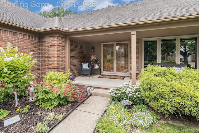 5131 Standish Dr, Troy, MI 48085 - entrance to property featuring brick siding, roof with shingles, and covered porch