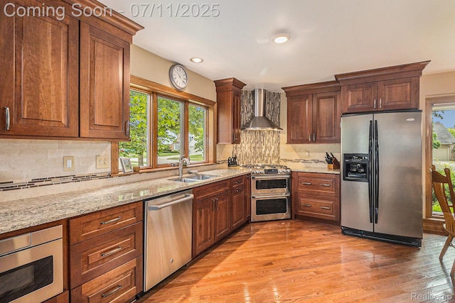 5131 Standish Dr, Troy, MI 48085 - kitchen featuring appliances with stainless steel finishes, wall chimney exhaust hood, tasteful backsplash, light stone counters, and recessed lighting