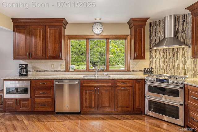 5131 Standish Dr, Troy, MI 48085 - kitchen featuring wall chimney range hood, appliances with stainless steel finishes, decorative backsplash, and light stone counters