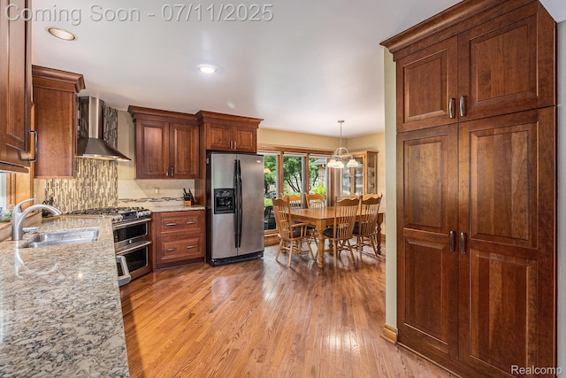 5131 Standish Dr, Troy, MI 48085 - kitchen featuring stainless steel appliances, wall chimney range hood, light wood-style floors, decorative backsplash, and recessed lighting