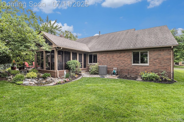 5131 Standish Dr, Troy, MI 48085 - rear view of property featuring roof with shingles, brick siding, a sunroom, and a lawn