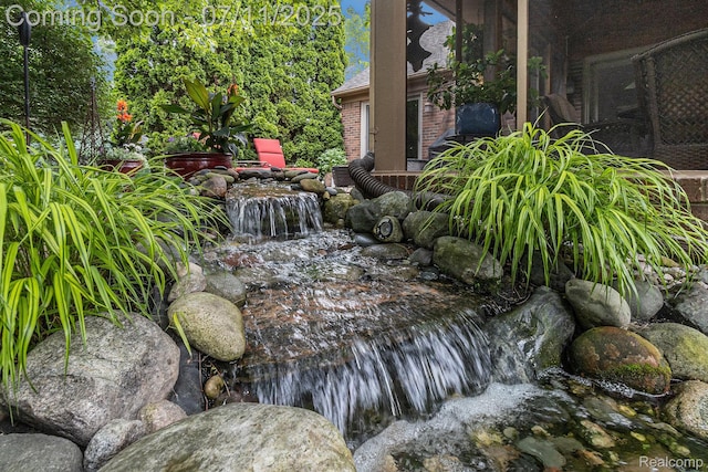 5131 Standish Dr, Troy, MI 48085 - exterior view of a small pond and brick siding