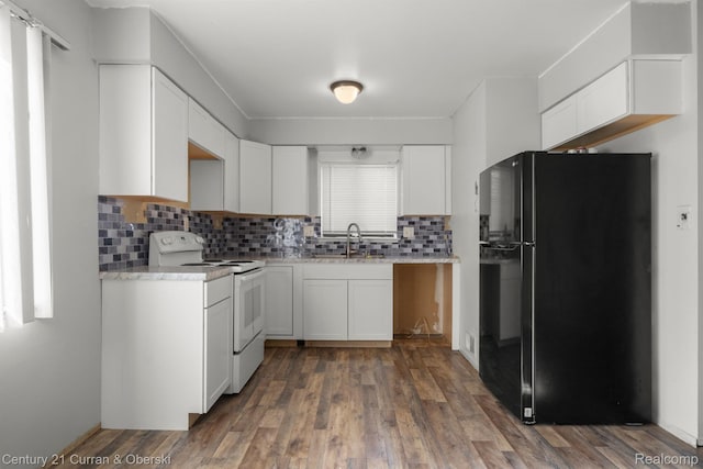 18949 Kenosha St, Harper Woods, MI 48225 - kitchen featuring freestanding refrigerator, electric stove, backsplash, and white cabinetry