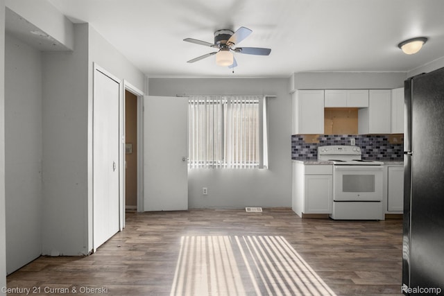 18949 Kenosha St, Harper Woods, MI 48225 - kitchen with white range with electric stovetop, freestanding refrigerator, ceiling fan, white cabinetry, and backsplash