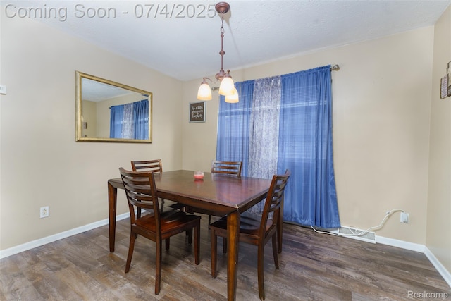 5771 Milett Rd, Fowlerville, MI 48836 - dining room featuring wood finished floors and a chandelier