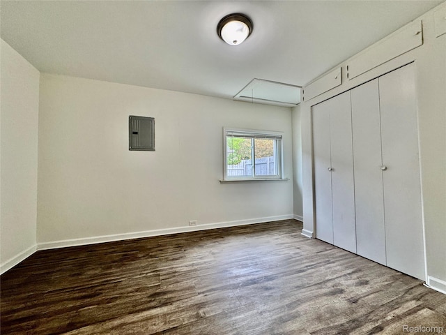 4915 Clarkston Rd, Clarkston, MI 48348 - unfurnished bedroom featuring attic access, wood finished floors, electric panel, and a closet