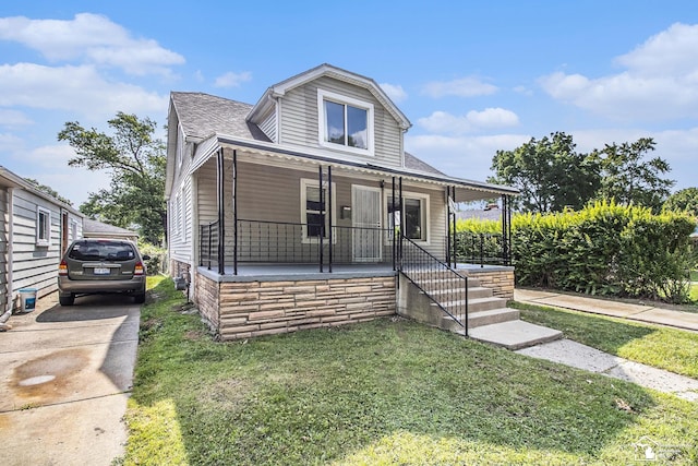 5369 Weddell St, Dearborn Heights, MI 48125 - bungalow-style house with covered porch, a front yard, and roof with shingles