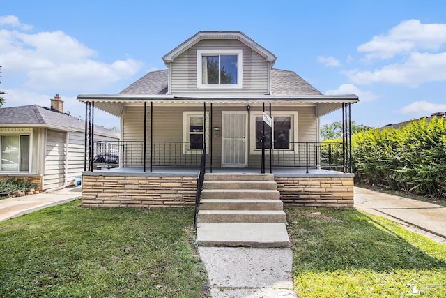 5369 Weddell St, Dearborn Heights, MI 48125 - bungalow with a porch, a shingled roof, and a front yard