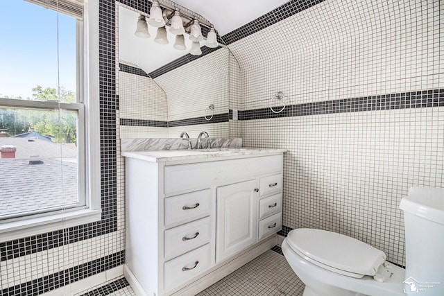 5369 Weddell St, Dearborn Heights, MI 48125 - bathroom featuring tile walls, vanity, healthy amount of natural light, and tile patterned floors
