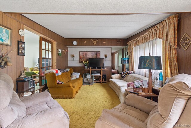4175 Cherokee St, Gladwin, MI 48624 - living room with wood walls, carpet floors, plenty of natural light, french doors, and a textured ceiling