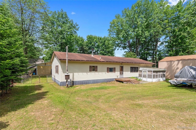 4175 Cherokee St, Gladwin, MI 48624 - rear view of house with a sunroom