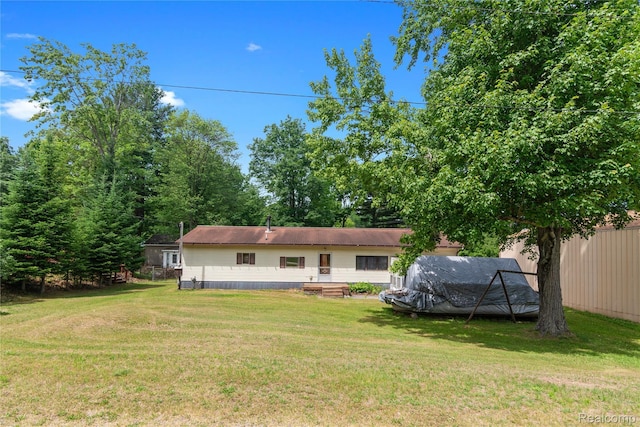 4175 Cherokee St, Gladwin, MI 48624 - back of house featuring a lawn