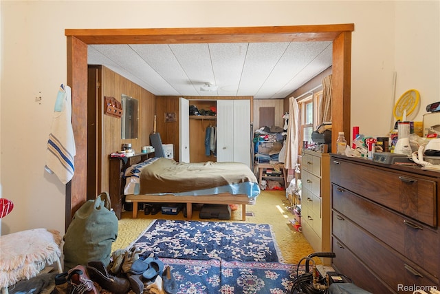 4175 Cherokee St, Gladwin, MI 48624 - bedroom featuring wooden walls, electric panel, and light colored carpet