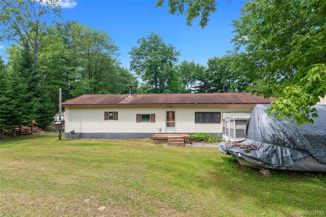 4175 Cherokee St, Gladwin, MI 48624 - rear view of house with a yard and a metal roof