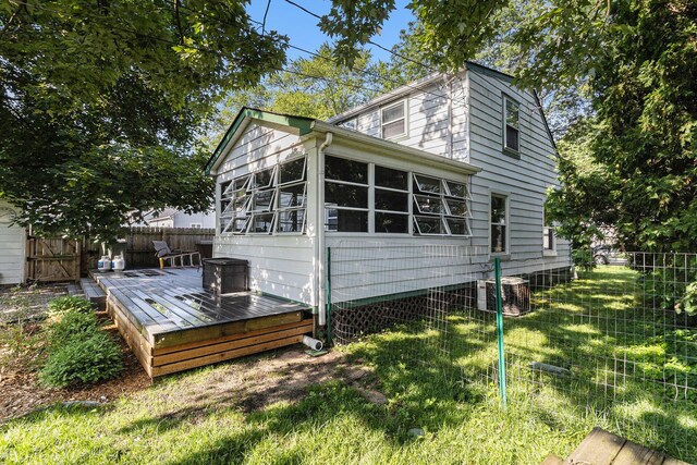 10351 Endicott St, Michigan, MI 48111 - rear view of property with a deck, a fenced backyard, and a sunroom